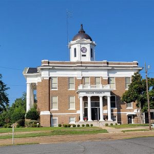 Multistory tan brick building with cupola