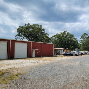 Red metal building with bay doors