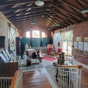 Room full of museum displays of dolls and other items