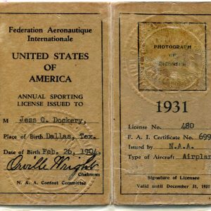 A yellow two-page booklet of the pilot license issued to Jess O. Dockery