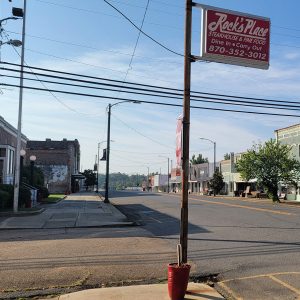 Storefront buildings and sidewalks on city street with no traffic