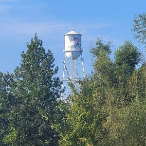 White cylindrical tower atop legs