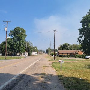 Small town road with houses and trees