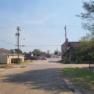 Small town road into commercial area with several buildings