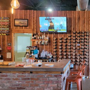 Interior of a brew house with bar and mugs hanging on back wall