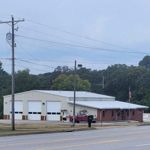 Multistory beige metal building with three bay doors and sign saying "Southside Fire Department"