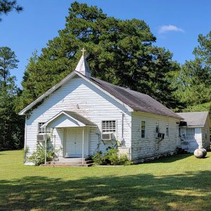 White wooden country church building with steeple