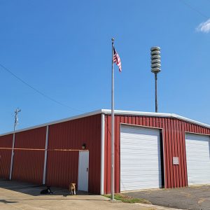 Single story red metal building two garage bay doors