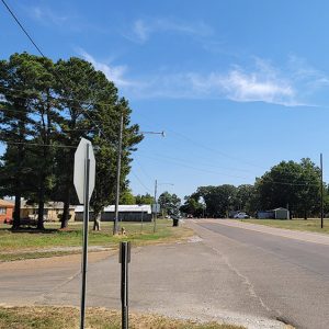 Small town street scene with intersection and a few houses