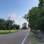 Small town street with houses and trees on both sides