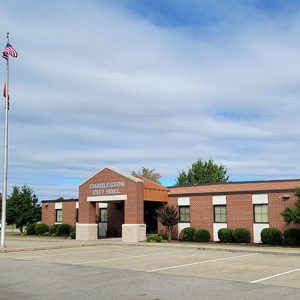 Single story red brick city hall building with covered entrance