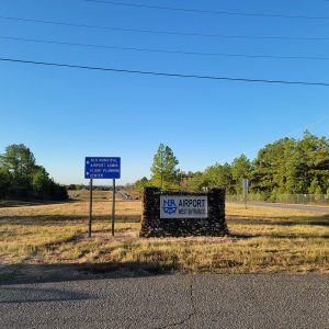 Airport entrance sign with road