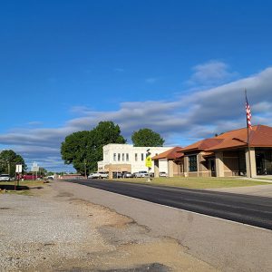 Small town street scene with businesses and traffic