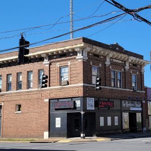 two-story red brick building at intersection