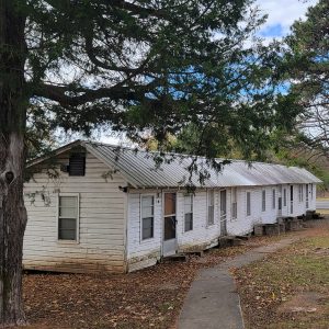 Single story white wooden row building