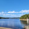 Looking across a lake to a distant shore and a small concrete structure