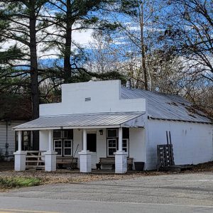 Single story white concrete block building with covered entrance