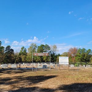 Cemetery behind chain link fence with gravestones