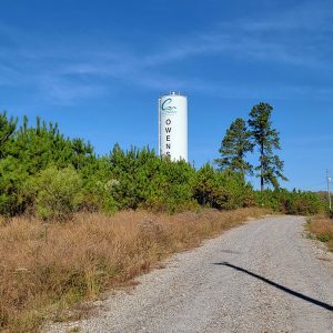 White metal cylinder with the beginning of the word "Owensville" visible