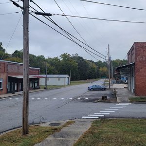 Small town street scene with empty-seeming storefront buildings