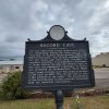 Metal sign with seal of Arkansas at the top giving information about Record Cave