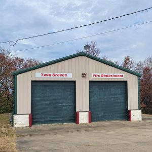 Single story metal building with two garage doors