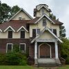 Multistory weathered wood and yellow stucco church building