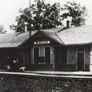 Single story white wooden depot building