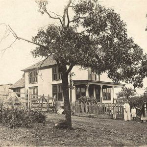 two white women and a child standing before large