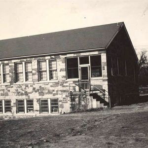 Multistory rock building with short staircase leading to entrance