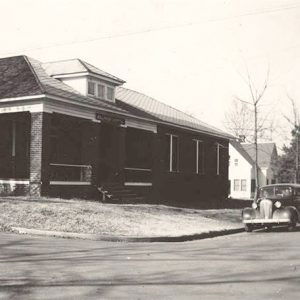 Single story brick house building with porch