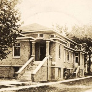 brick church building with steps leading up to entrance