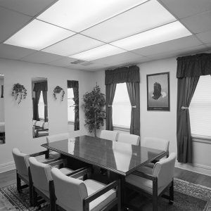 Room interior with table and chairs and mirrors on the walls