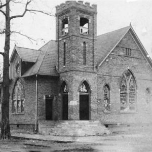 Multistory brick church building with bell tower