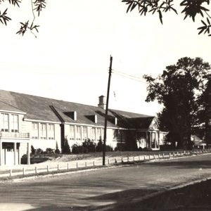 Long two-story building lined with windows