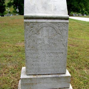 faded tombstone in cemetery