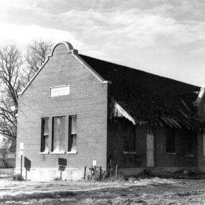 Brick depot building with boarded up windows