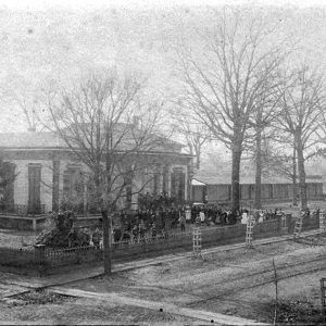 Large group of white people standing in front of school building