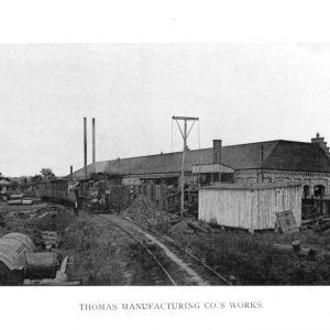 Single story building beside railroad tracks