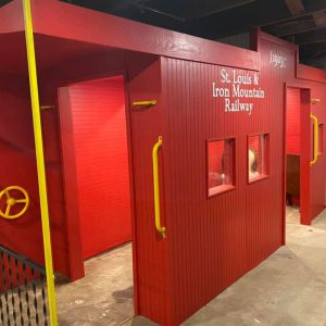 Replica of a red railroad car in a museum display