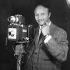 African American man in suit standing by camera