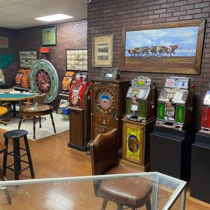 Row of antique slot machines among other exhibits