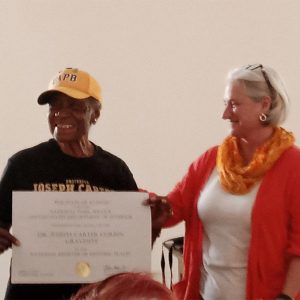 African American woman and white woman holding a certificate