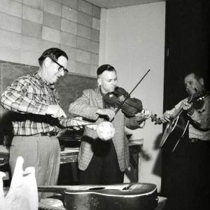 Three white men playing instruments