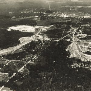 Aerial view of a town and mining areas in the country with trees around