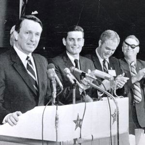 Six white men on a stage