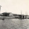 Wooden dock on a lake and wooden buildings on the shore