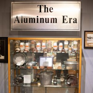 Museum display holding many aluminum items