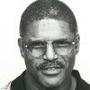 African American man in striped shirt and glasses