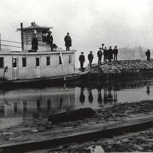 Boat and barge hauling oyster shells